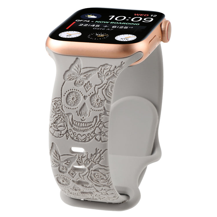 Relief 8-Character Buckle Skull Carving Silicone Watch Strapwith a decorative skull and floral patterned band on a white background